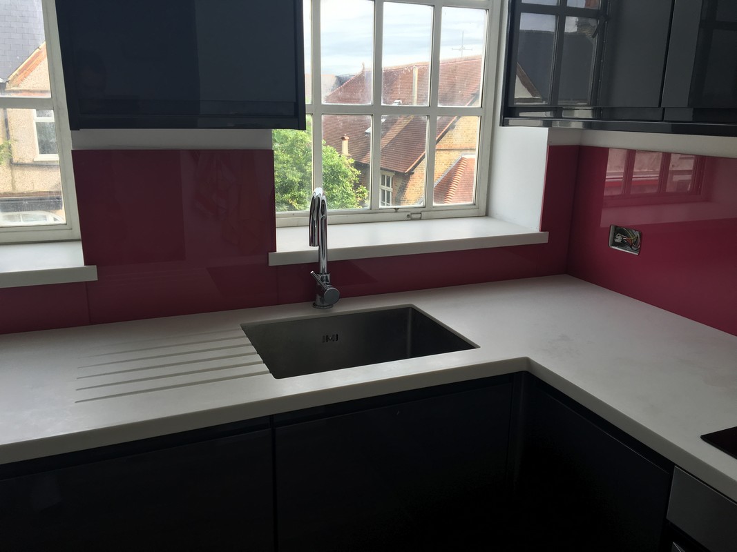 Deep plum coloured glass splashback in modern Mayfair kitchen