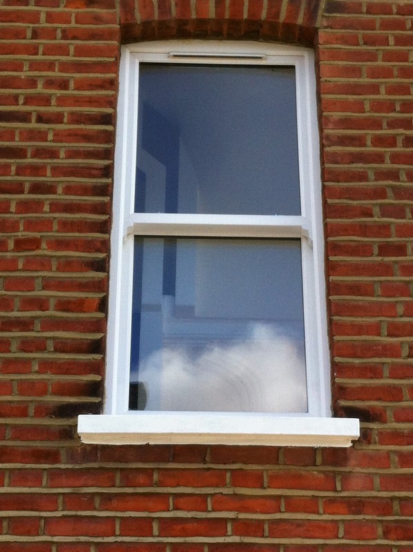 uPVC sash window on Victorian red brick house in Mayfair